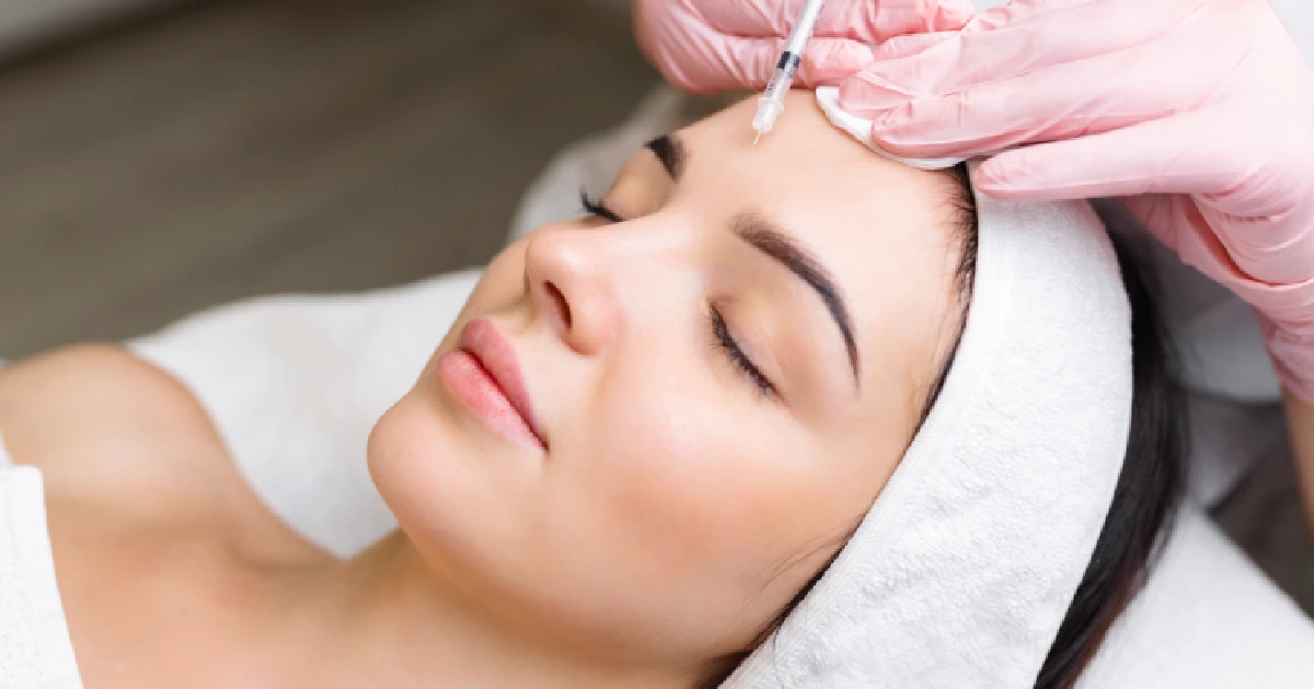A woman receiving a toxin Treatments in Fort Myers, FL, for forehead wrinkle reduction