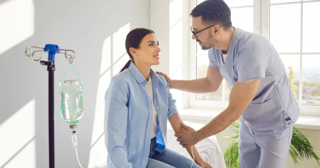 Healthcare provider speaking with a female patient during an IV therapy session for Vitamin Injections in Fort Myers, FL.